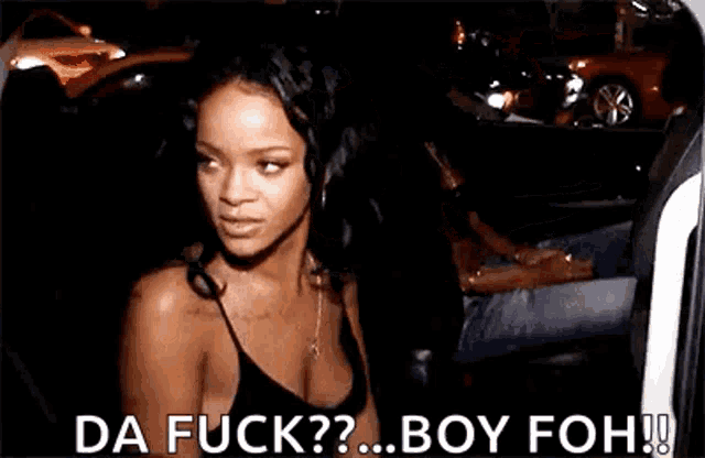 a woman in a black tank top is standing in front of a car and says da fuck ? boy foh !