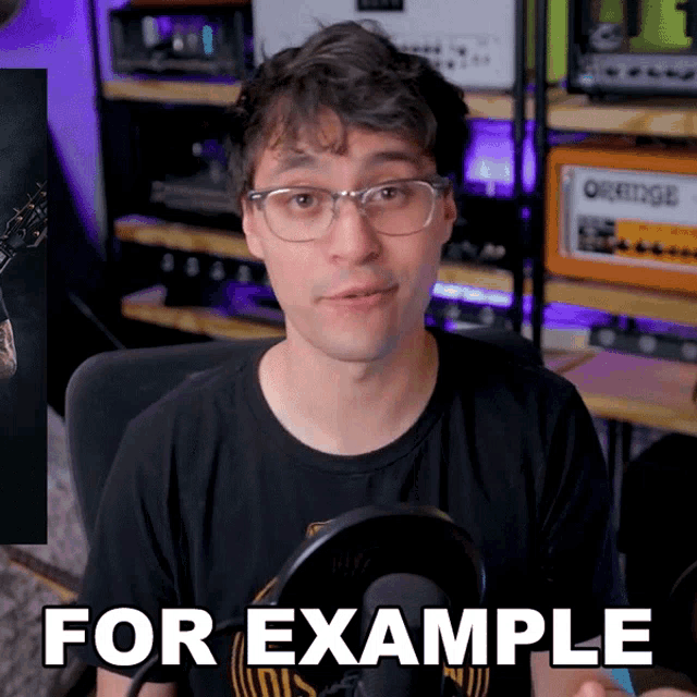 a man wearing glasses is sitting in front of a microphone with the words for example behind him