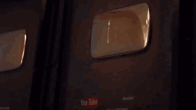 a close up of a youtube badge on a dark background