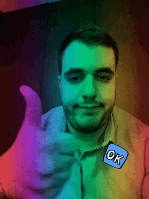 a man giving a thumbs up with a sticker that says ok
