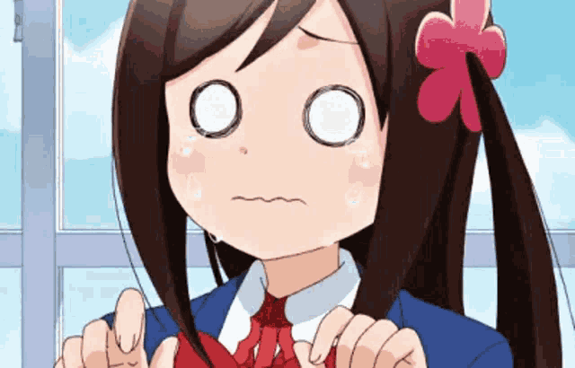 a girl with a flower in her hair making a sad face