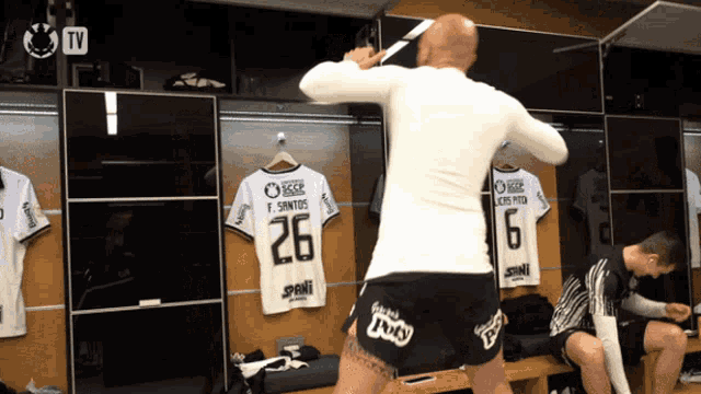 a man in a white shirt with the number 26 on the back
