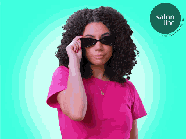a woman wearing sunglasses and a pink shirt with a salon line logo in the corner