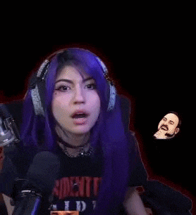 a woman with purple hair is wearing headphones and a t-shirt that says resident evil .