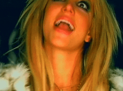 a close up of a woman making a funny face with her mouth open