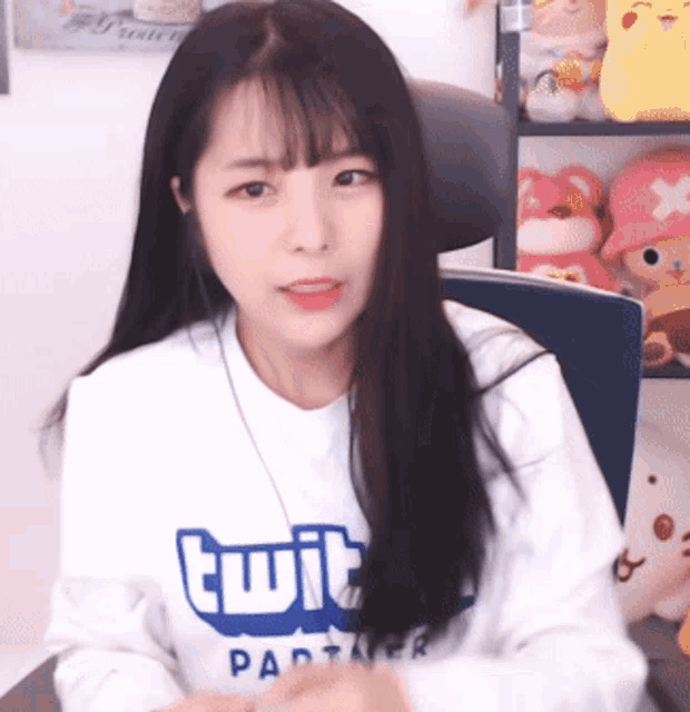 a girl is wearing a white sweater with the word twit on it