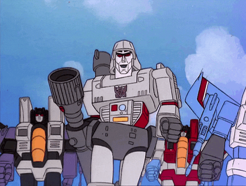 a group of transformers are standing together and one of them has a gun