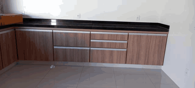 a kitchen with wooden cabinets and a black granite counter top