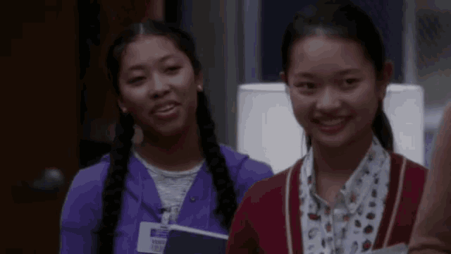 two girls are standing next to each other and one has a name tag that says ' victoria ' on it