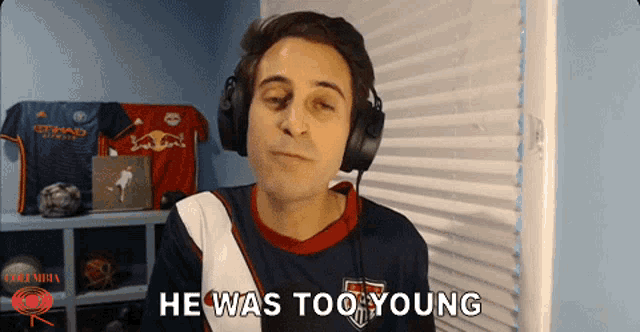 a man wearing headphones with the words he was too young on the bottom