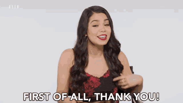 a woman says " first of all thank you " in front of a white background