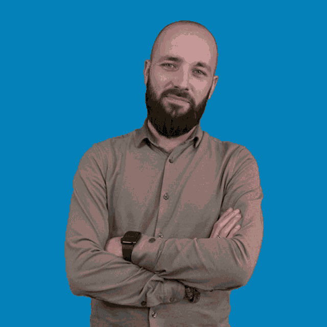 a bald man with a beard wears a smart watch on his wrist