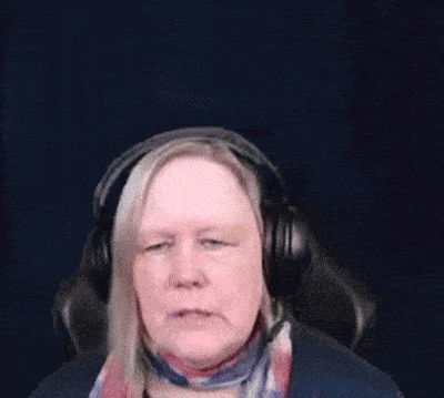 a woman wearing headphones is sitting in a chair .