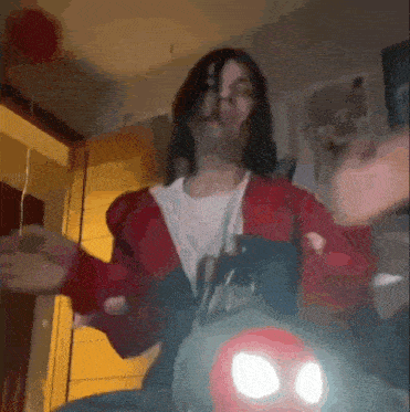 a woman in a red jacket and white shirt is sitting on a motorcycle .