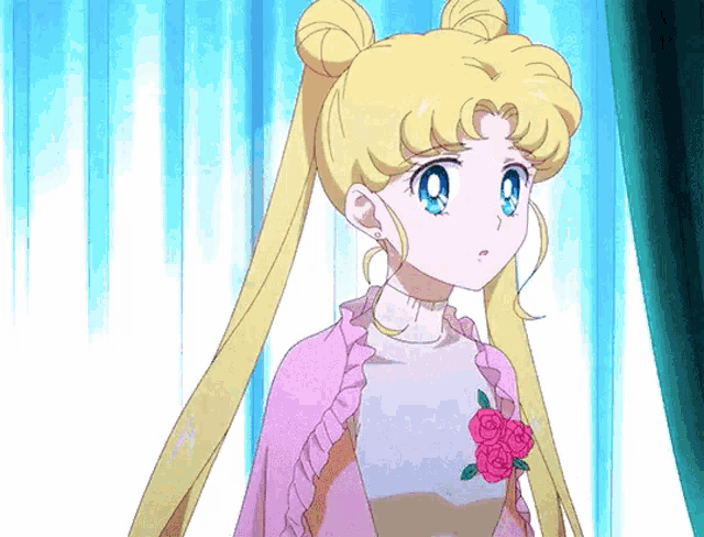 a girl with blonde hair is wearing a pink sweater with roses on it