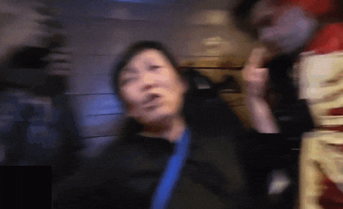 a blurry picture of a man and a woman with a skeleton in the background