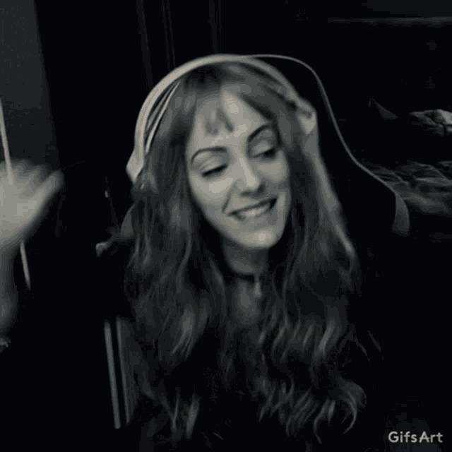 a woman wearing headphones is dancing in a black and white photo