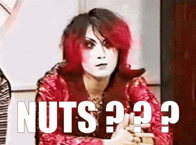 a woman with red hair has the word nuts written in white