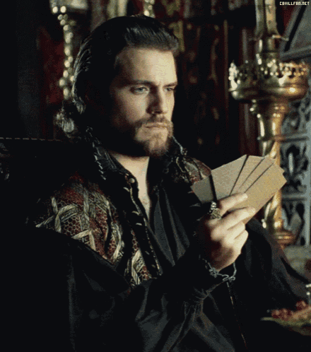 a man with a beard is holding a stack of cards in his hand and a watermark that says chillfire.net