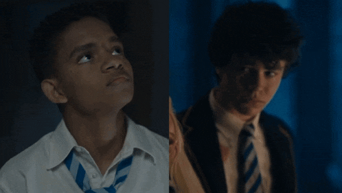 a boy in a white shirt and blue tie is next to a boy in a suit and tie