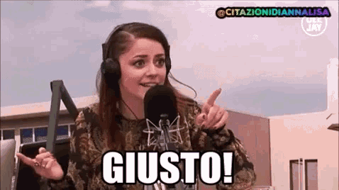 a woman wearing headphones is talking into a microphone and says giusto !