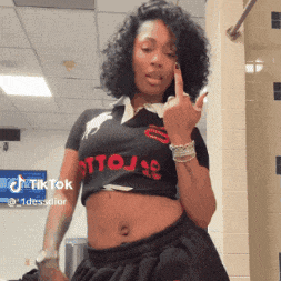 a woman wearing a crop top that says " ottoj " on it