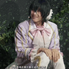 a man in a purple and white outfit with a pink bow