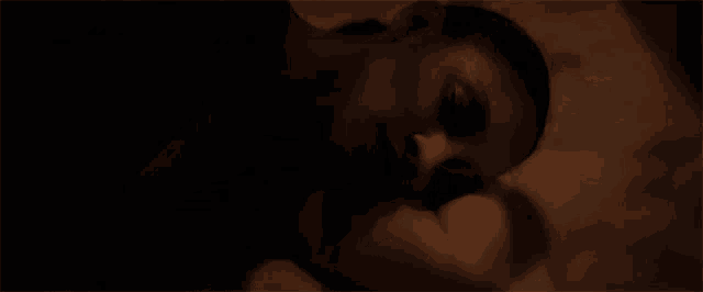 a close up of a person 's face with a black background