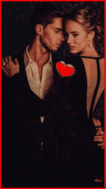 a man in a suit and a woman in a dress are hugging each other in a red frame