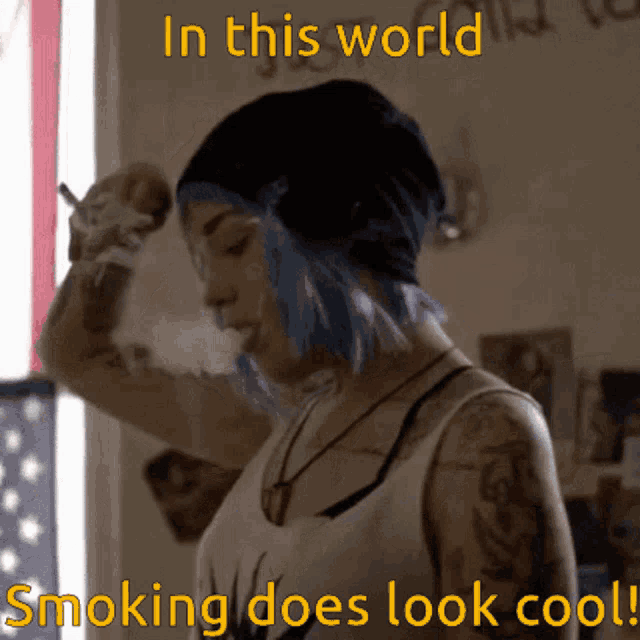 a woman with blue hair smoking a cigarette with the words in this world smoking does look cool below her