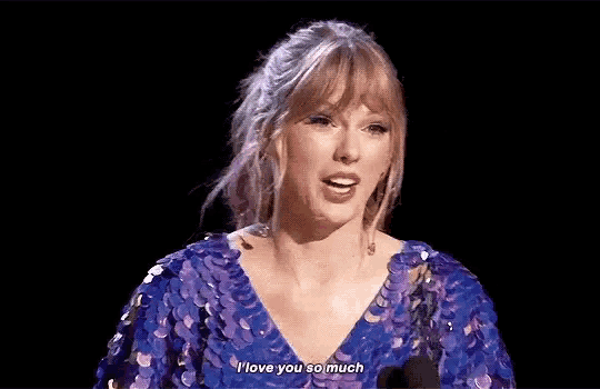 a woman in a purple sequined dress is talking into a microphone and saying `` i love you so much '' .