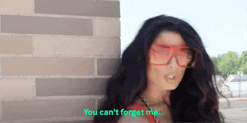 a woman wearing sunglasses is standing in front of a brick wall and says you can 't forget me