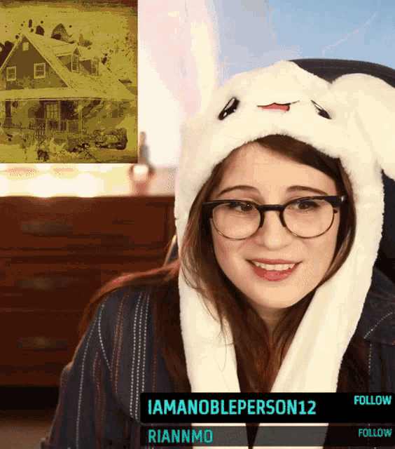 a woman wearing glasses and a bunny hat is being followed by rianmo