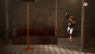 a football player in front of a banner that says cleveland browns on it
