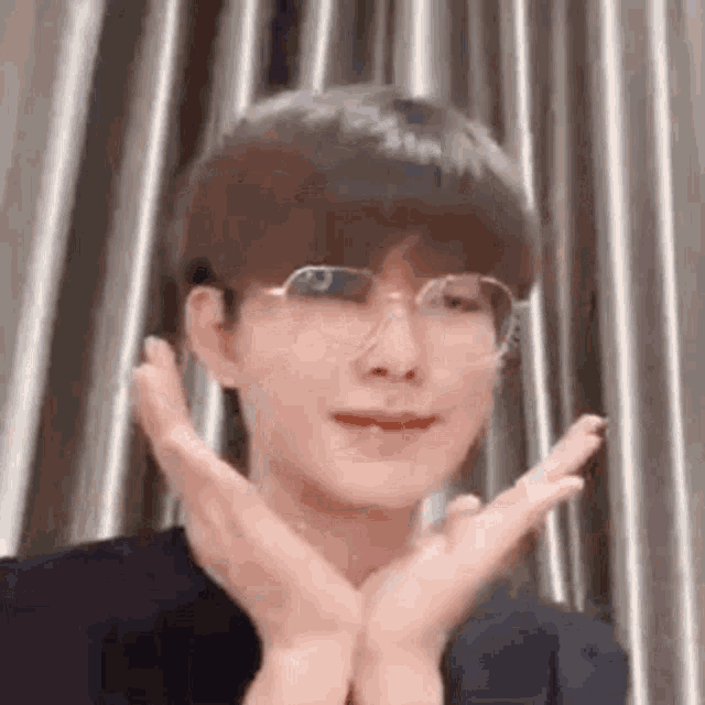 a close up of a person wearing glasses and making a face .