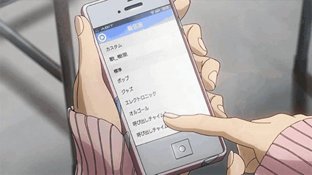 a person is holding a cell phone with a list of songs on it