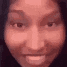 a close up of a woman 's face making a funny face with her mouth open .