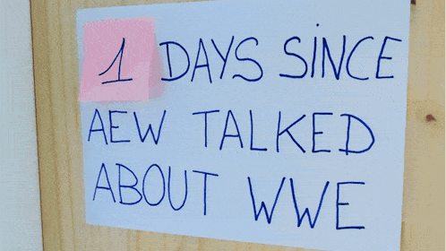 a sign on a wooden wall that says days since aew talked about wwe