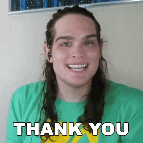 a man with long hair and a green shirt says " thank you "