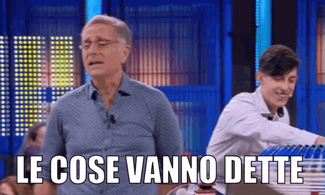 a man is standing next to a boy with the words le cose vanno dette written on the screen