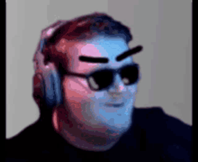 a man wearing headphones and sunglasses looks like he is making a funny face