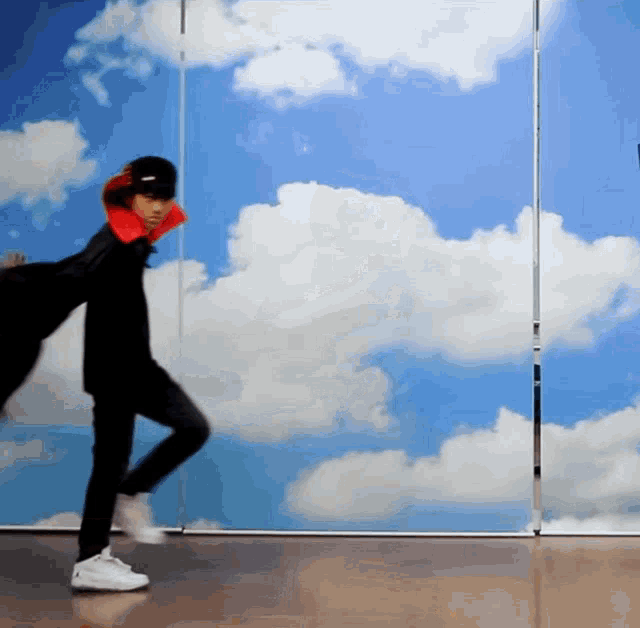 a person standing in front of a cloudy sky