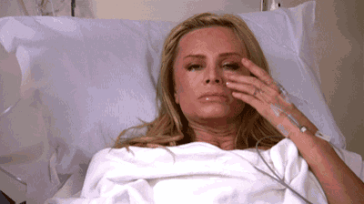 a woman in a hospital bed with an iv in her hand