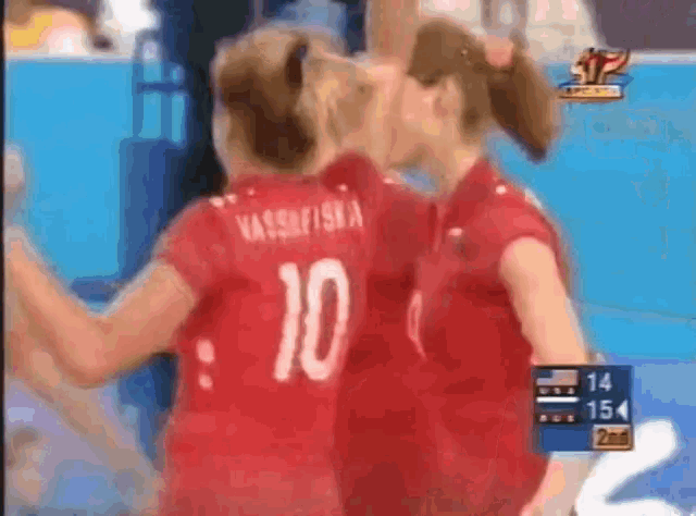 two volleyball players wearing red jerseys with the number 10 on the back