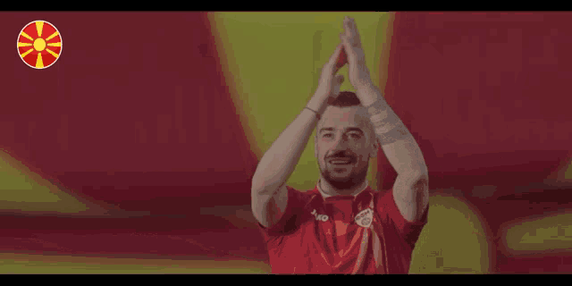 a man in a red shirt with jako on the front