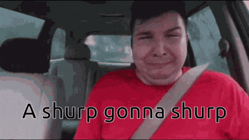 a man in a red shirt is sitting in the back seat of a car with his eyes closed .
