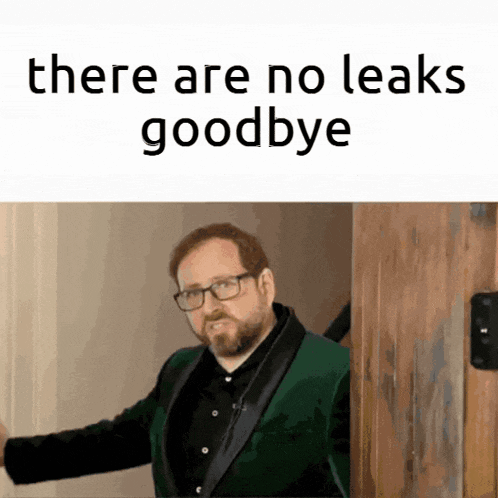a man in a green suit is standing in front of a door with the words there are no leaks goodbye above him