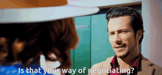 a man talking to a woman with the words is that your way of negotiating on the screen