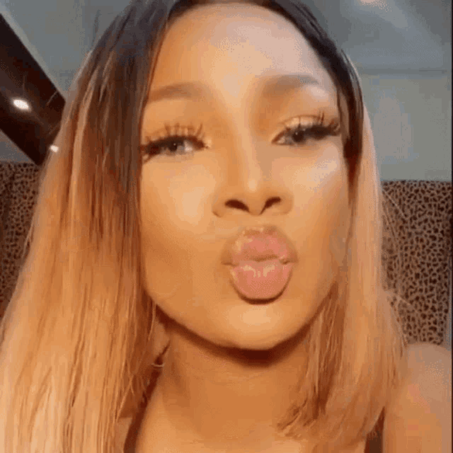 a woman is making a funny face with her lips .