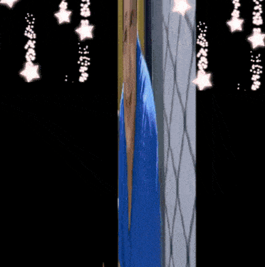 a person in a blue robe stands in front of a window